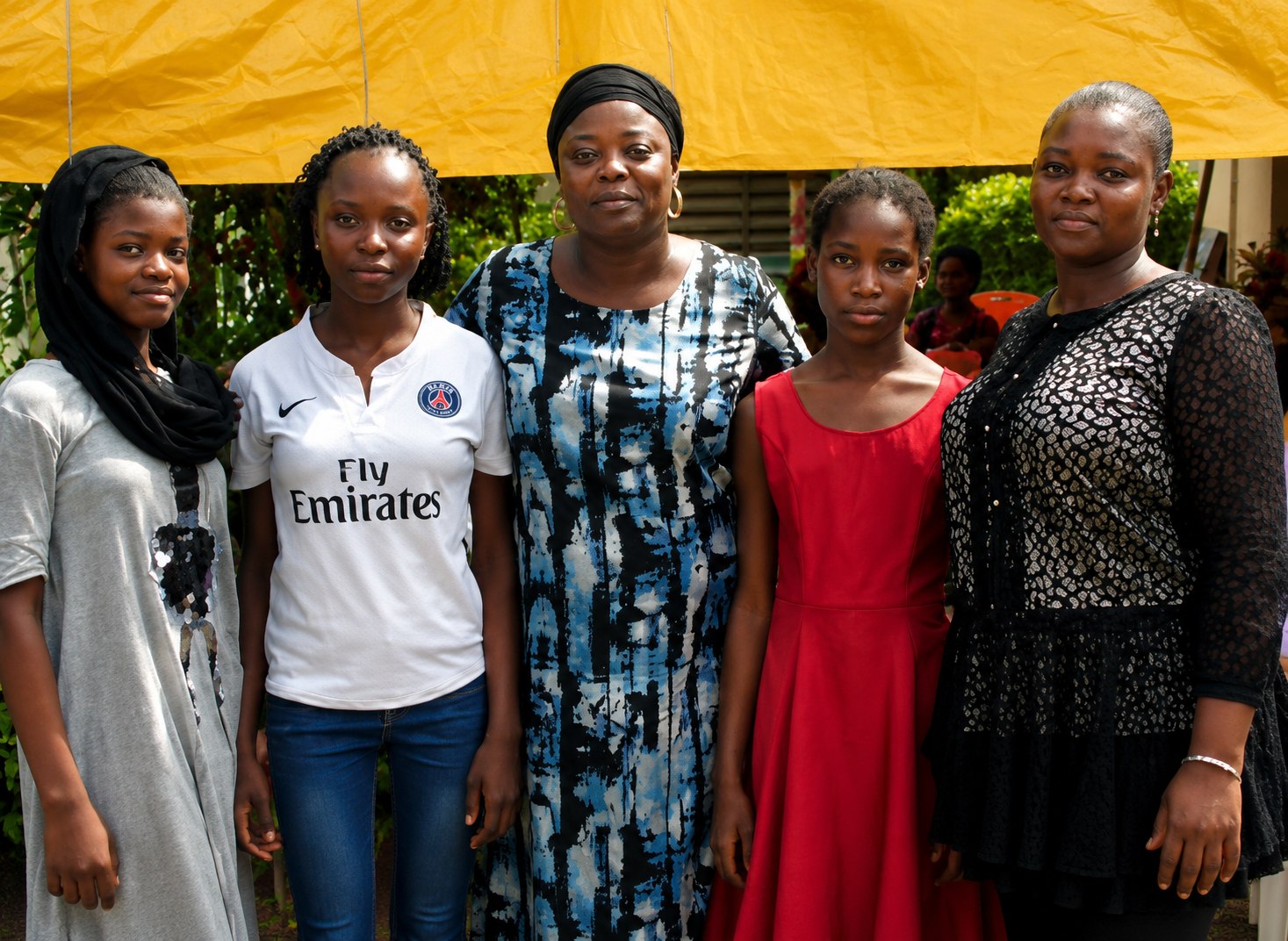 TGGF mentors and participants under an event canopy