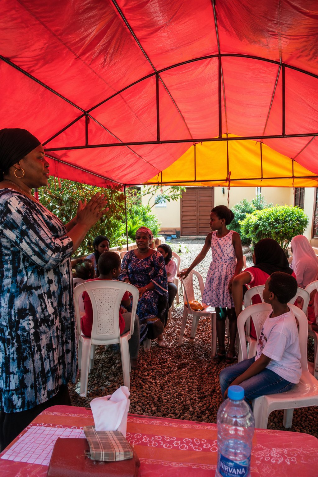 A TGGF facilitator leading a session under an outdoor canopy